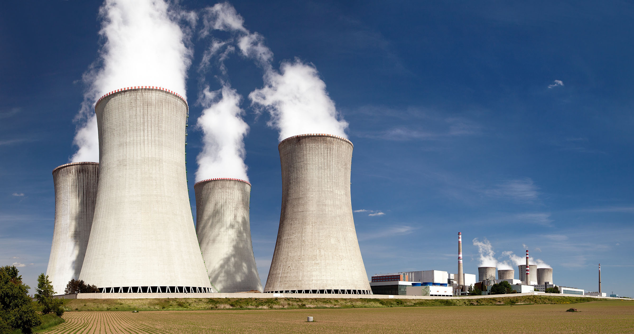 A depiction of a nuclear power plant and its cooling towers.
